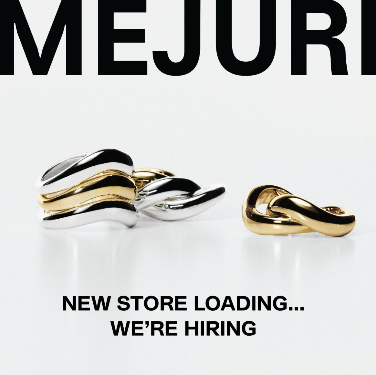 Two gold and silver rings from Mejuri announcing their store opening
